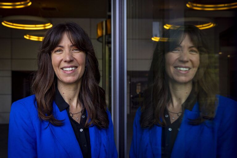 a woman reflected in a window